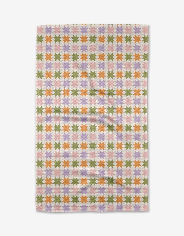 Spring-themed quilted tea towel with waffle weave texture in pastel green.