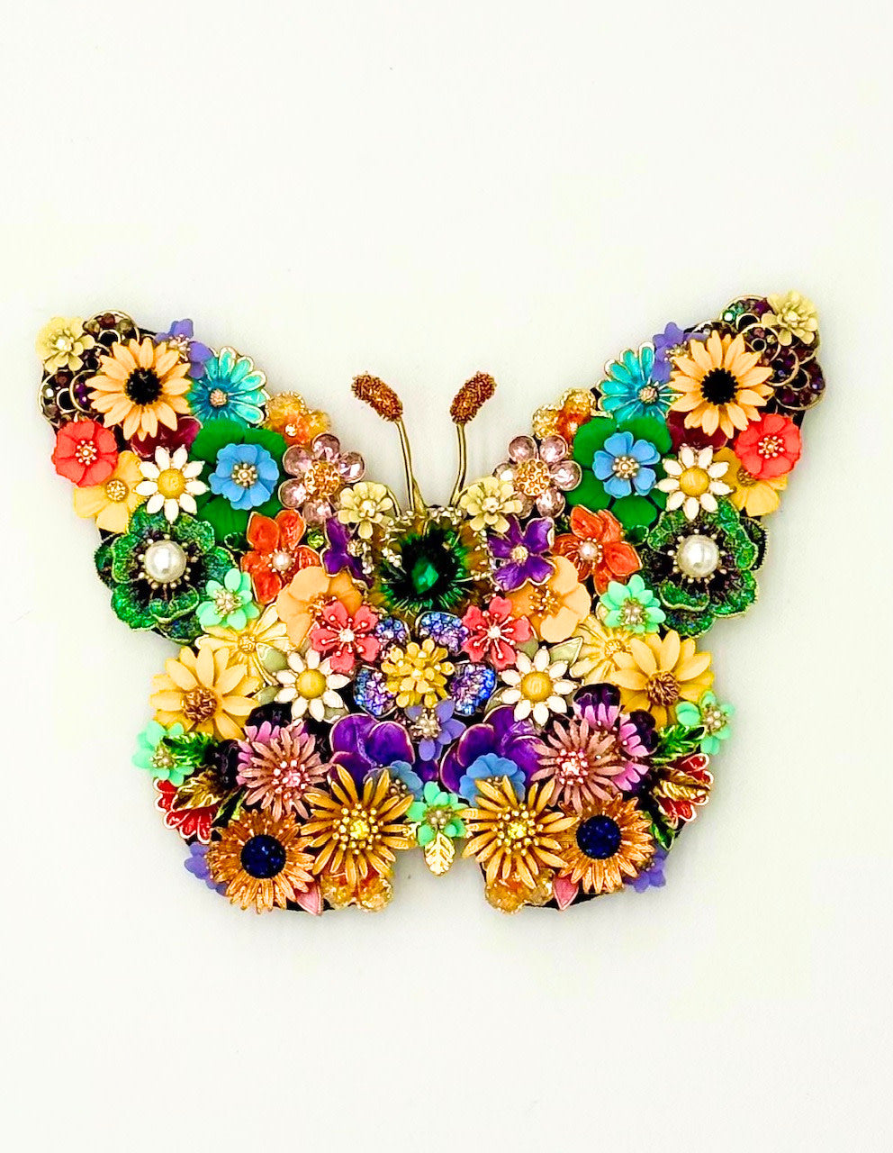 Handmade butterfly wall decor in spring green with delicate wing patterns.