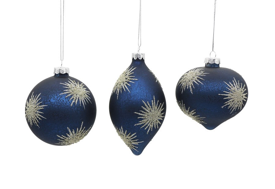 Three blue glass ornaments in round, teardrop, and onion shapes with silver glitter starbursts.