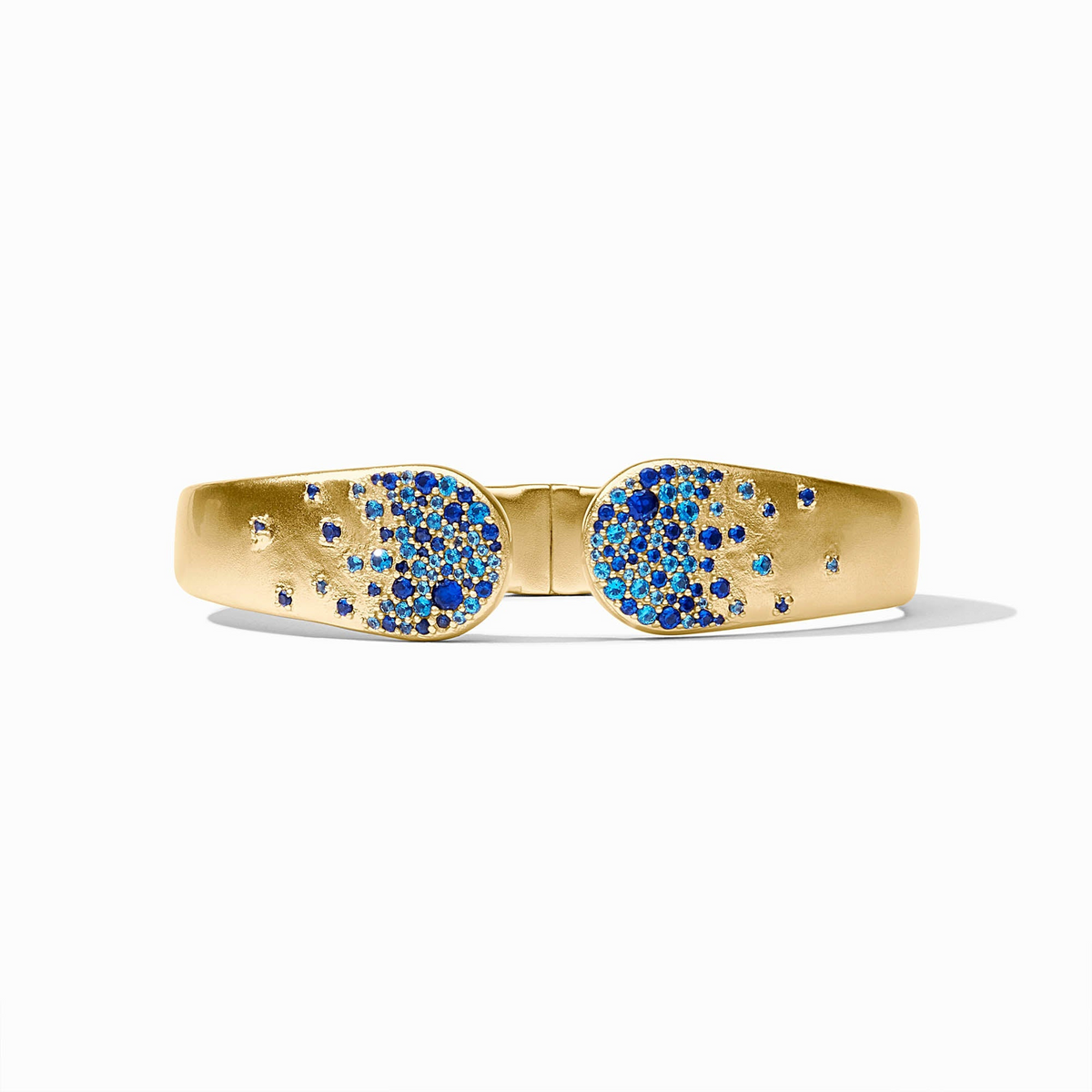 Gold Stardust Cuff Bracelet with blue sapphire cubic zirconia accents and a spring hinge closure.