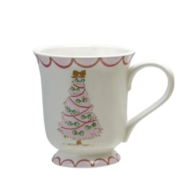White stoneware mug with a pink Christmas tree design, green bows, and scalloped pink trim.