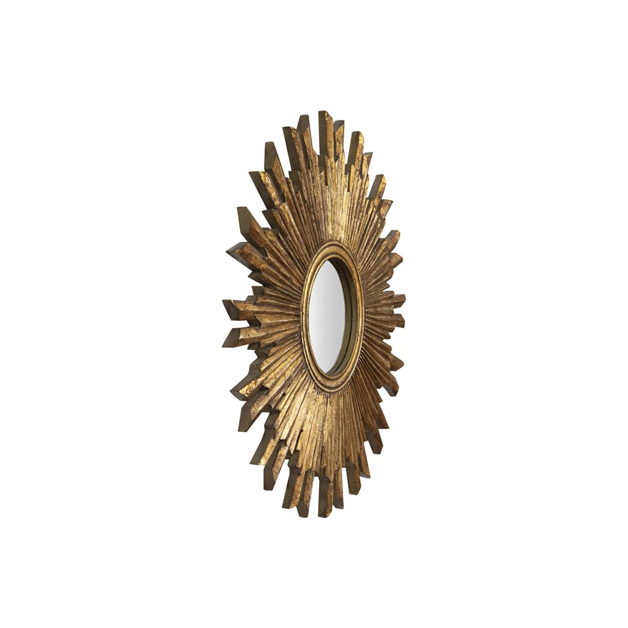 Side view of a round sunburst wall mirror with a gilded gold wood frame and radiating rays.