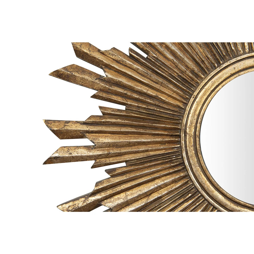 Close-up of a gold wood sunburst wall mirror featuring an intricate gilded frame design.
