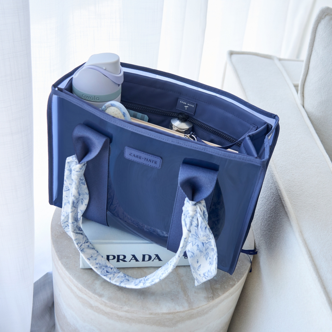 Blue medium tote organizer insert inside a matching jelly tote bag with a water bottle and items.
