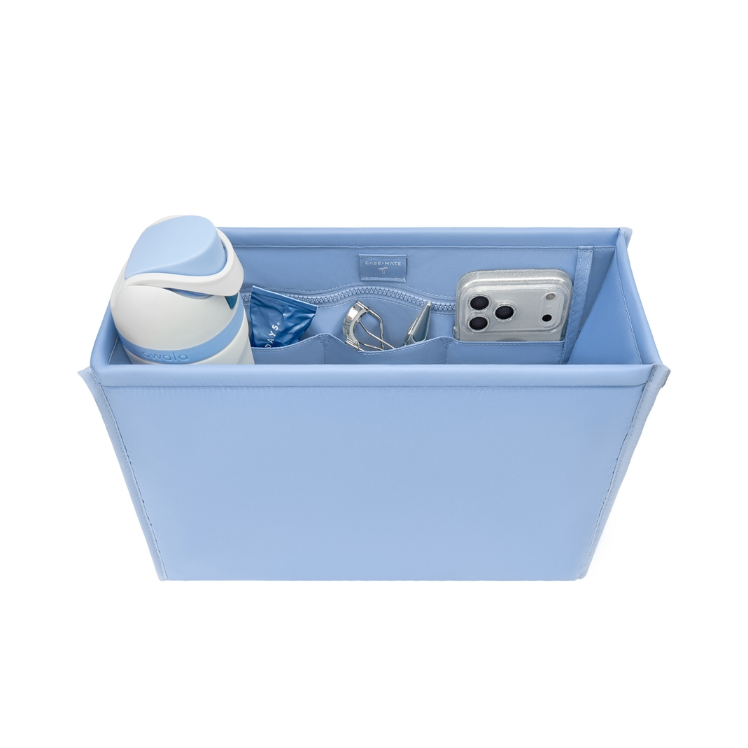 Light blue medium tote organizer insert filled with a water bottle, phone, and small accessories.