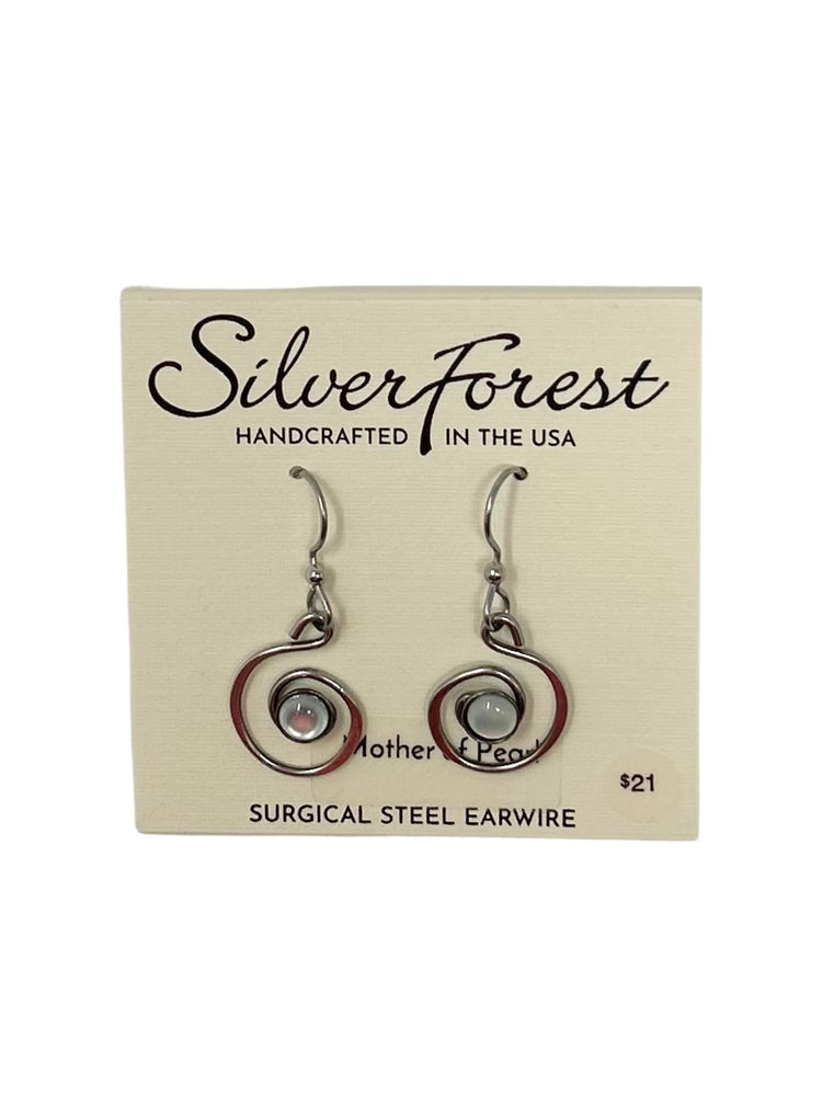 Hammered gold coil earrings with a bold artistic stone center on surgical steel fish hook backs.