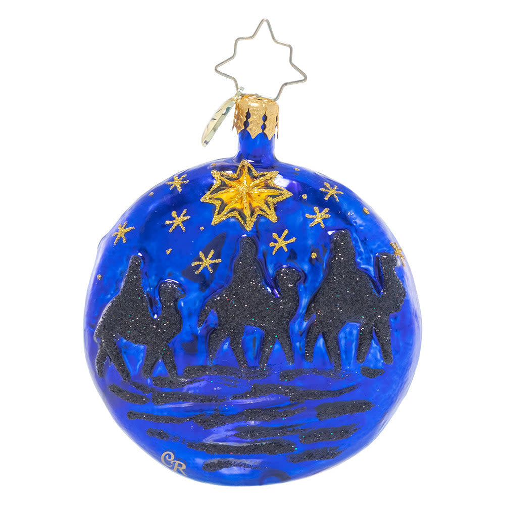 Double-sided wooden ornament shaped like a gem with gold stars on one side and three wise men journeying at night on the other.
