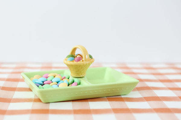 Mini woven basket in pastel pink with a handle, designed as an Easter egg hunt container.