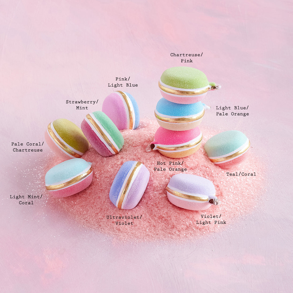 Hand-painted glass ornament shaped like a half rainbow macaron with gold leaf accents
