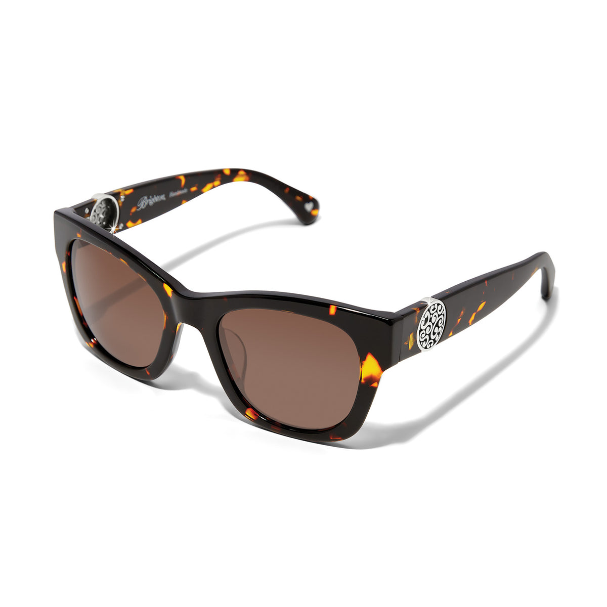 Tortoise shell cat eye sunglasses with silver medallion accents and brown lenses.