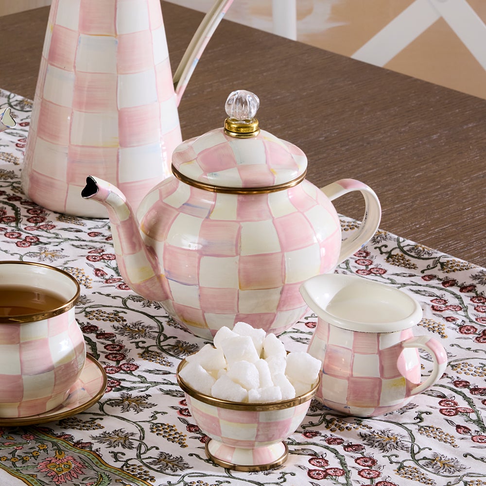 Hand-glazed steel teapot with hand-painted rosy check pattern on a bronzed stainless rim and glass finial lid.