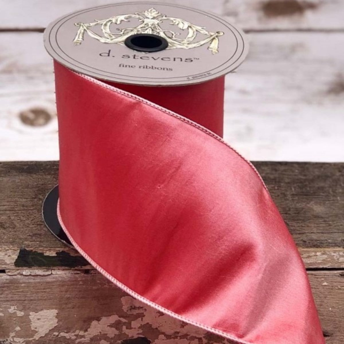 4-inch wide hot pink taffeta ribbon on a d. stevens spool, featuring a subtle sheen and wired edges.