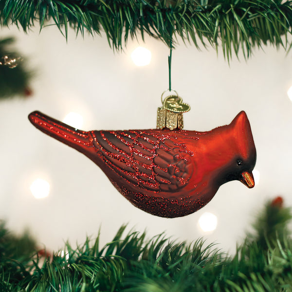 Glassblown Northern Cardinal ornament with red body, black mask, orange beak, and white wing accents.