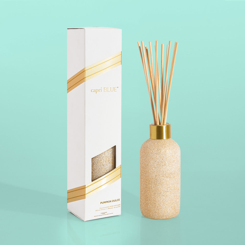 Glam Reed Diffuser in Pumpkin Dulce color with a cylindrical glass bottle holding scented oil and reed sticks.