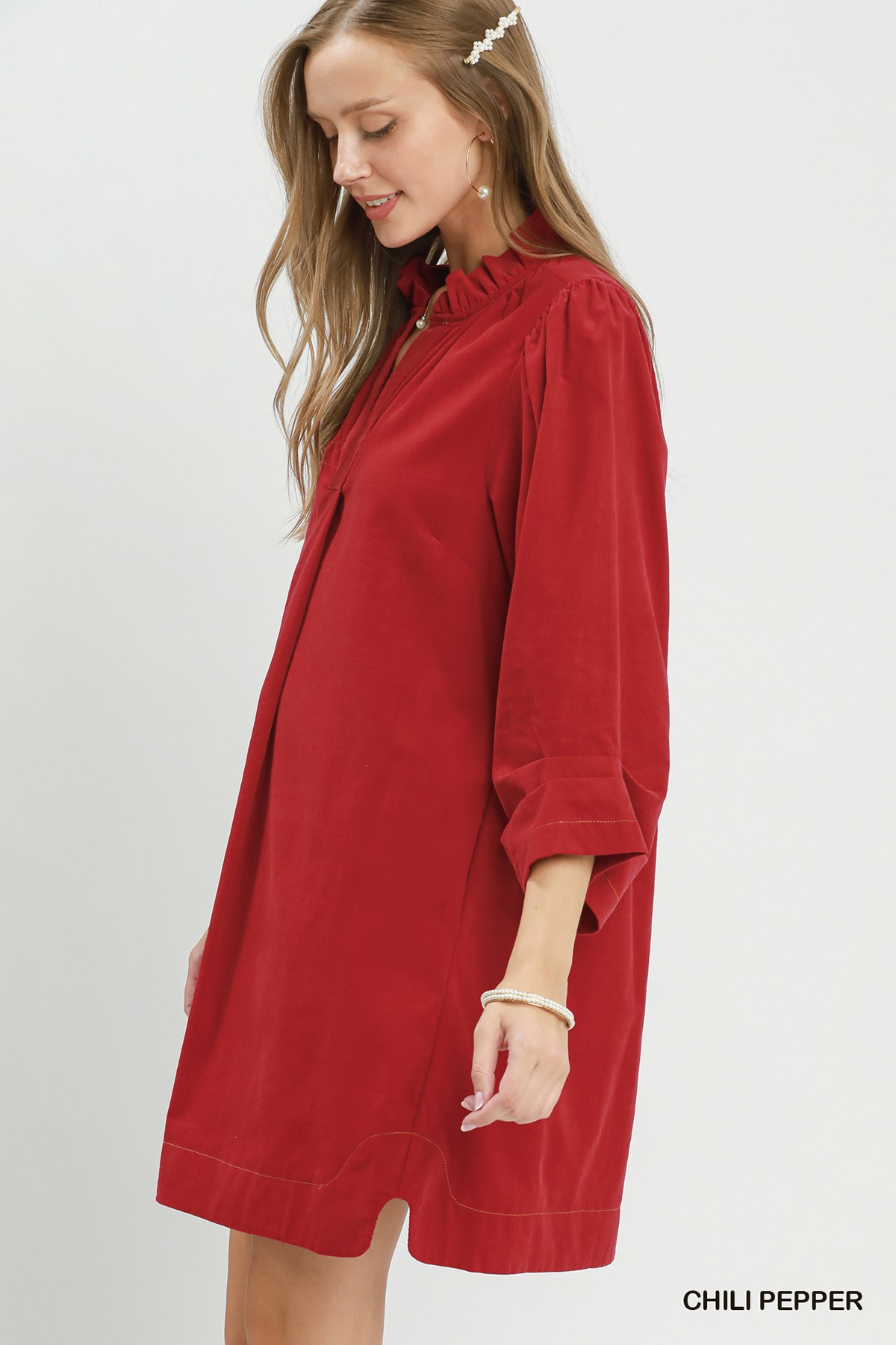 Woman wearing a red Olivia Corduroy Split Neck Puff Sleeve Shift Dress.