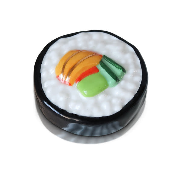 Mini sushi roll with visible rice, nori seaweed wrapper, and fillings on a white plate.