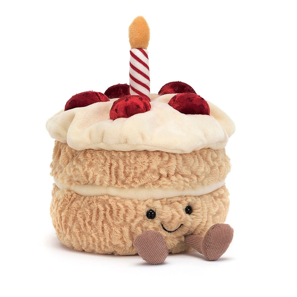 Amuseables Birthday Cake plush toy with tussly fur body, squashy buttercream hat topped with strawberries and striped candle.