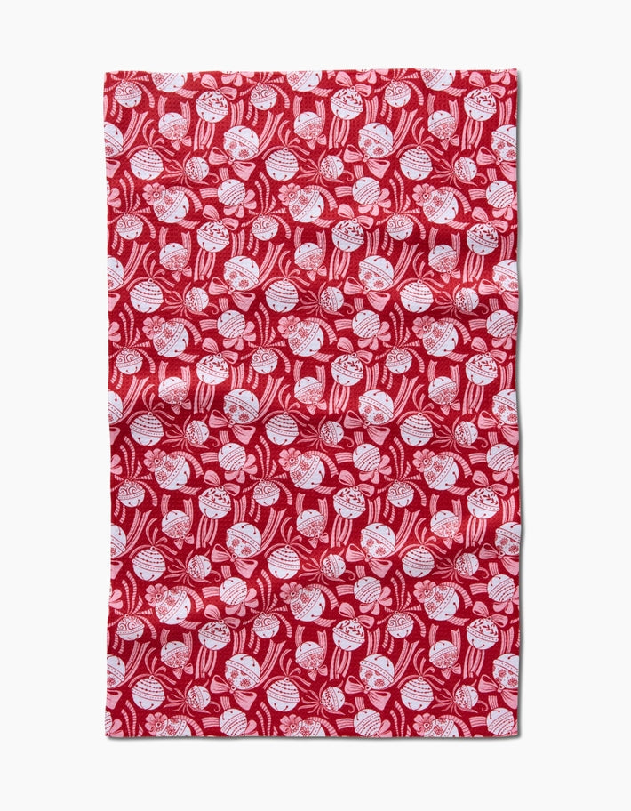 Holiday tea towel with waffle weave construction in red featuring a festive snowflake pattern.
