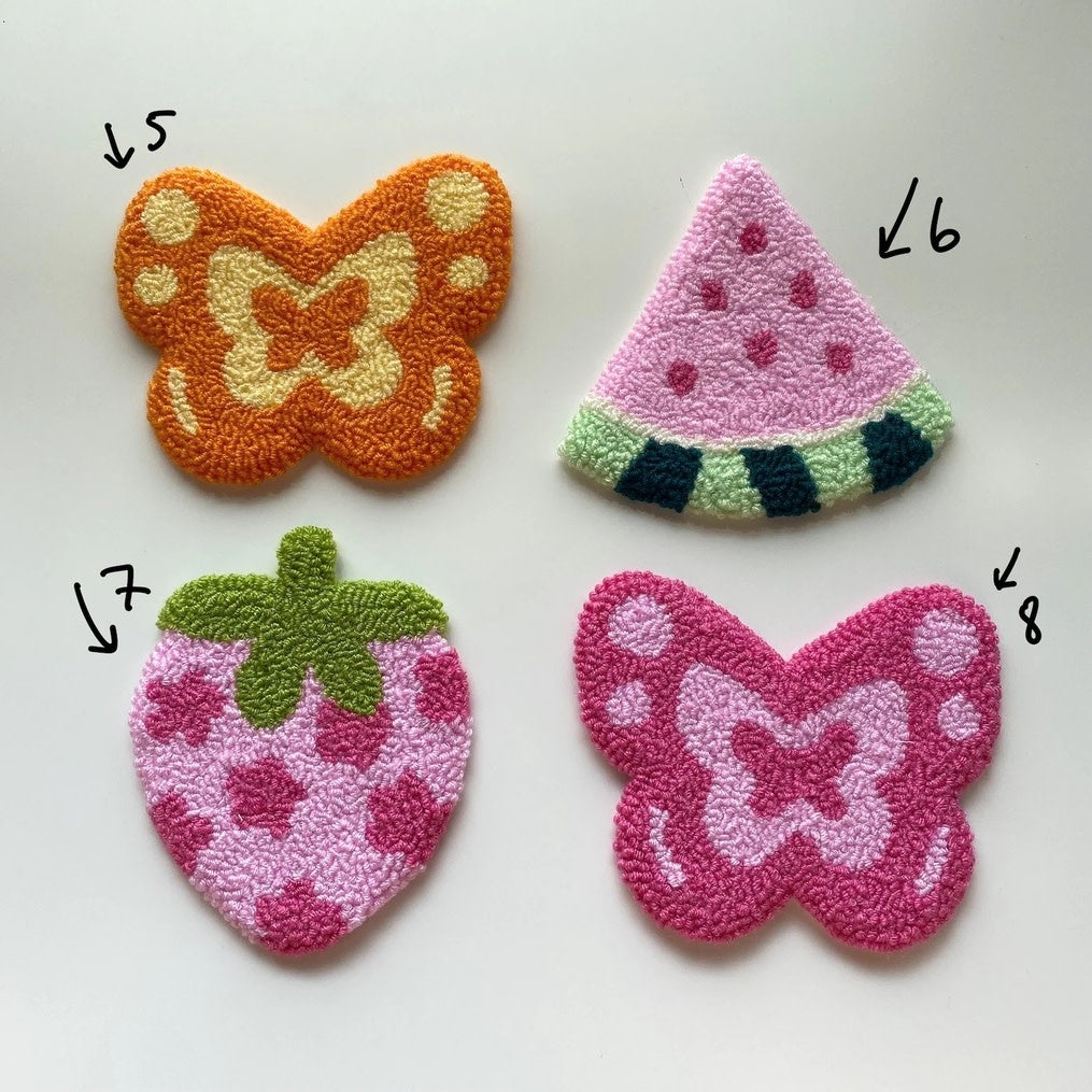 Handmade punch needle coaster with geometric patterns in earth tones