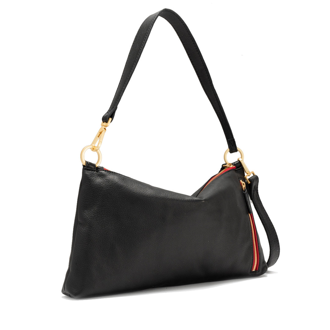 Black pebble leather Kyle Med crossbody bag with brushed gold hardware and red twill lining.