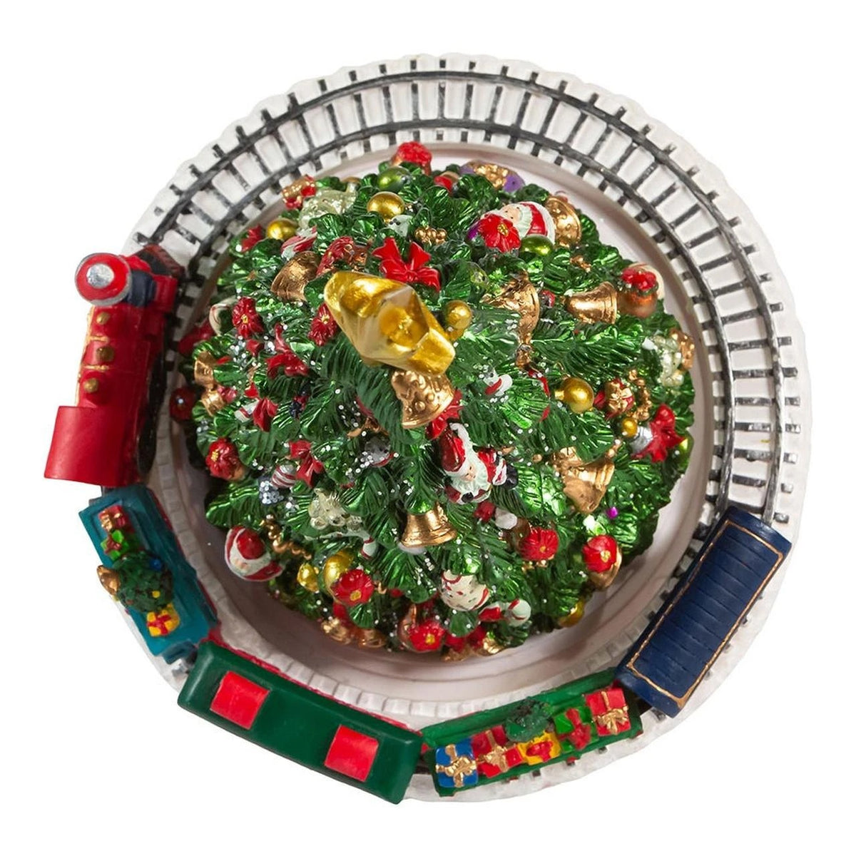 Top view of a decorated Christmas tree music box with a colorful revolving train on a circular track
