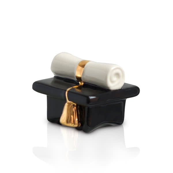 Black ceramic graduation cap figurine with a gold tassel and a white rolled diploma on top.