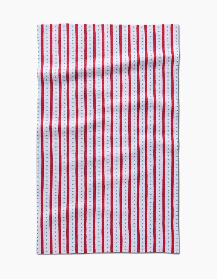 Holiday tea towel with waffle weave construction in red featuring a festive pattern