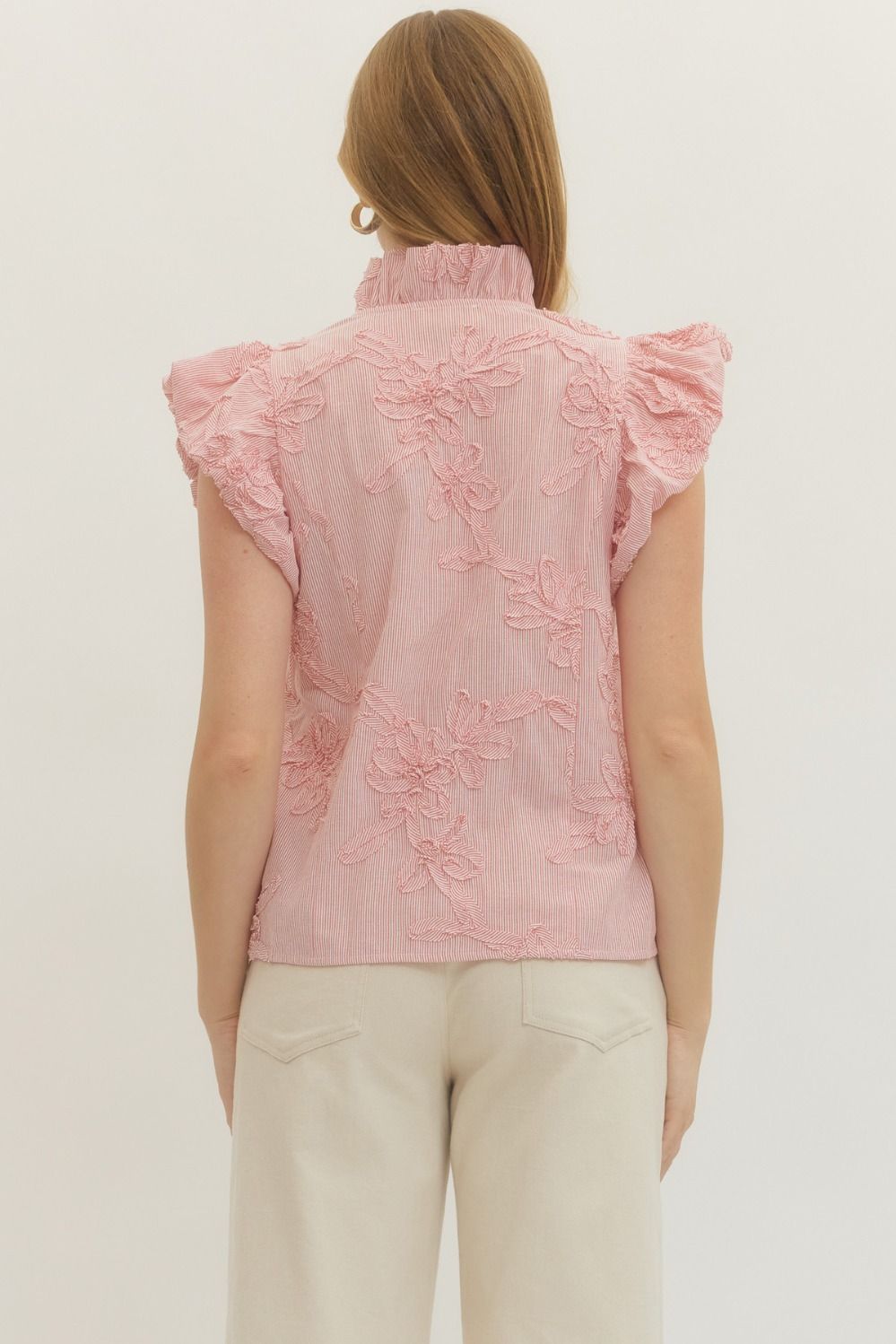 Leslie striped cotton top with floral appliqué, ruffled mock neck, flutter sleeves, and button front closure.