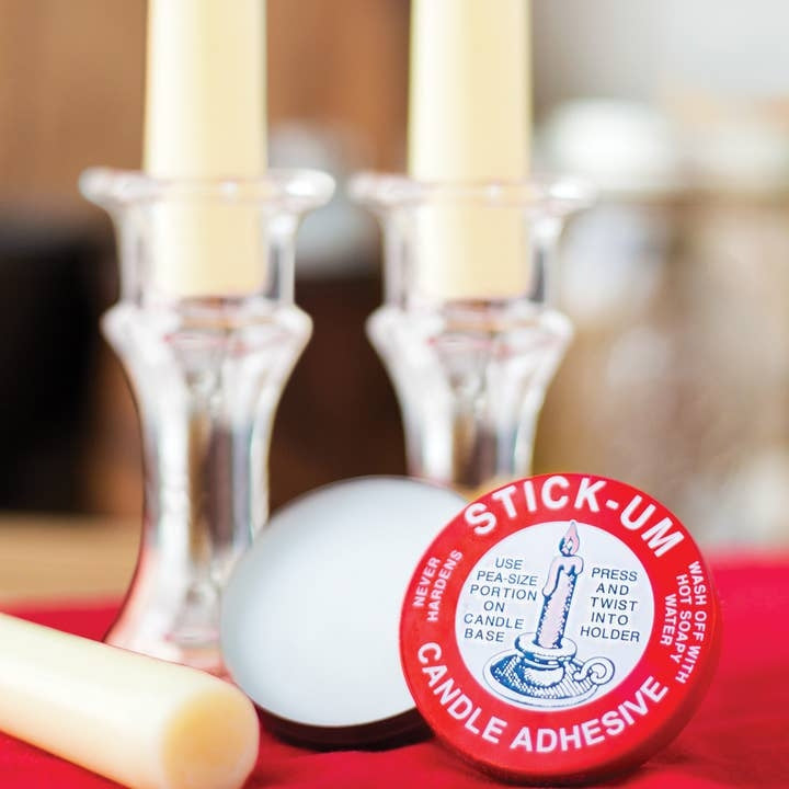 Small round tin of Fox Run Stick-Um Candle Adhesive in a neutral color.