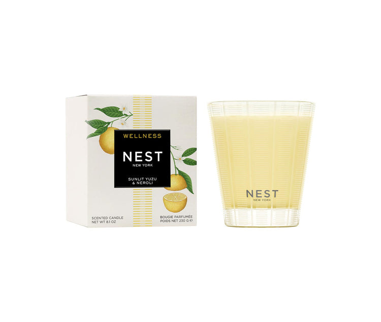 Nest Classic Candle in Sunlit Yuzu & Neroli with its white and yellow illustrated packaging.