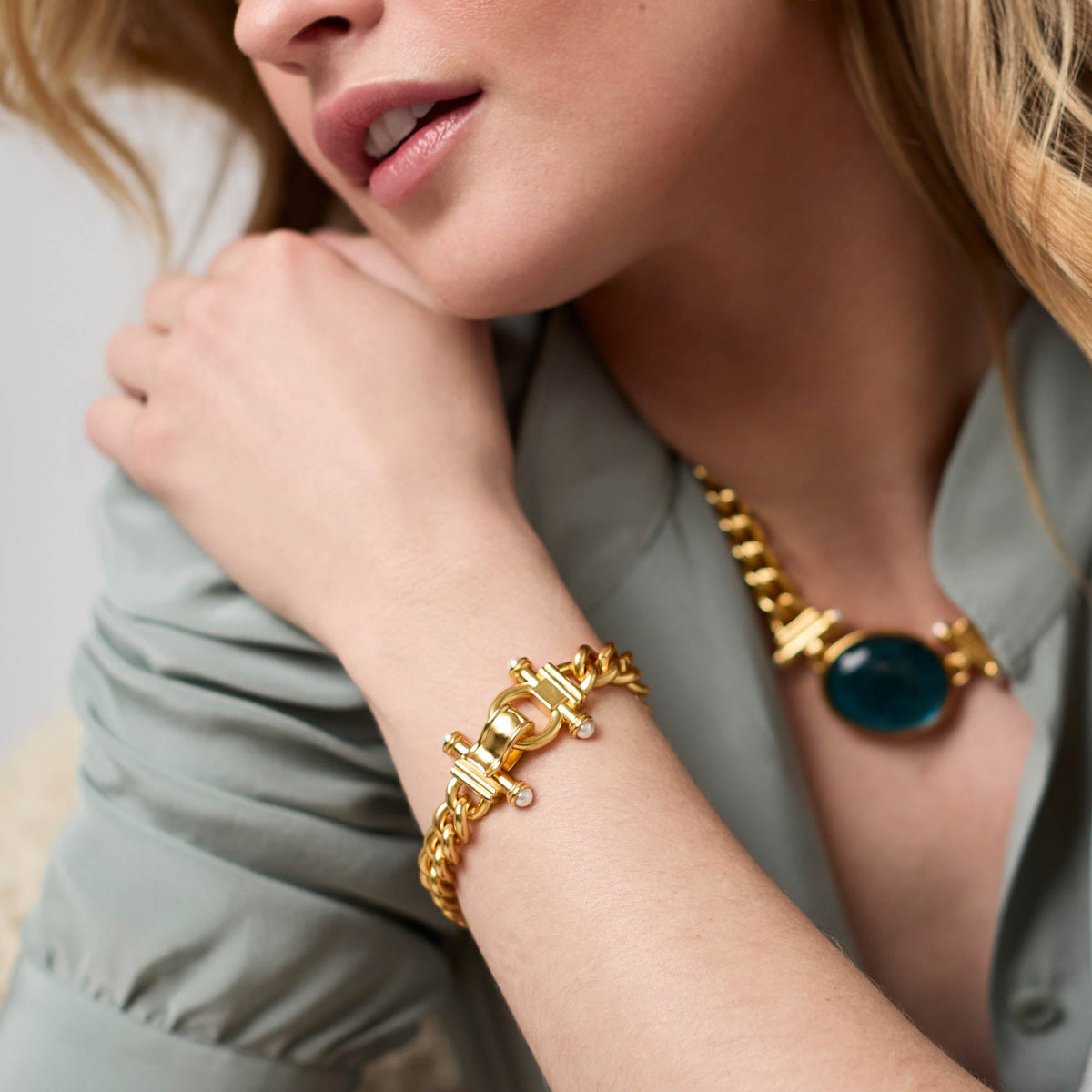 Woman wearing a Dolce Demi Link Bracelet in 24K gold plate with glass pearl accents.