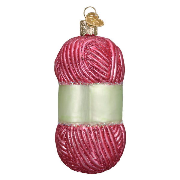 Pink glittery glass knitting yarn skein Christmas ornament with a white band and gold heart tag.