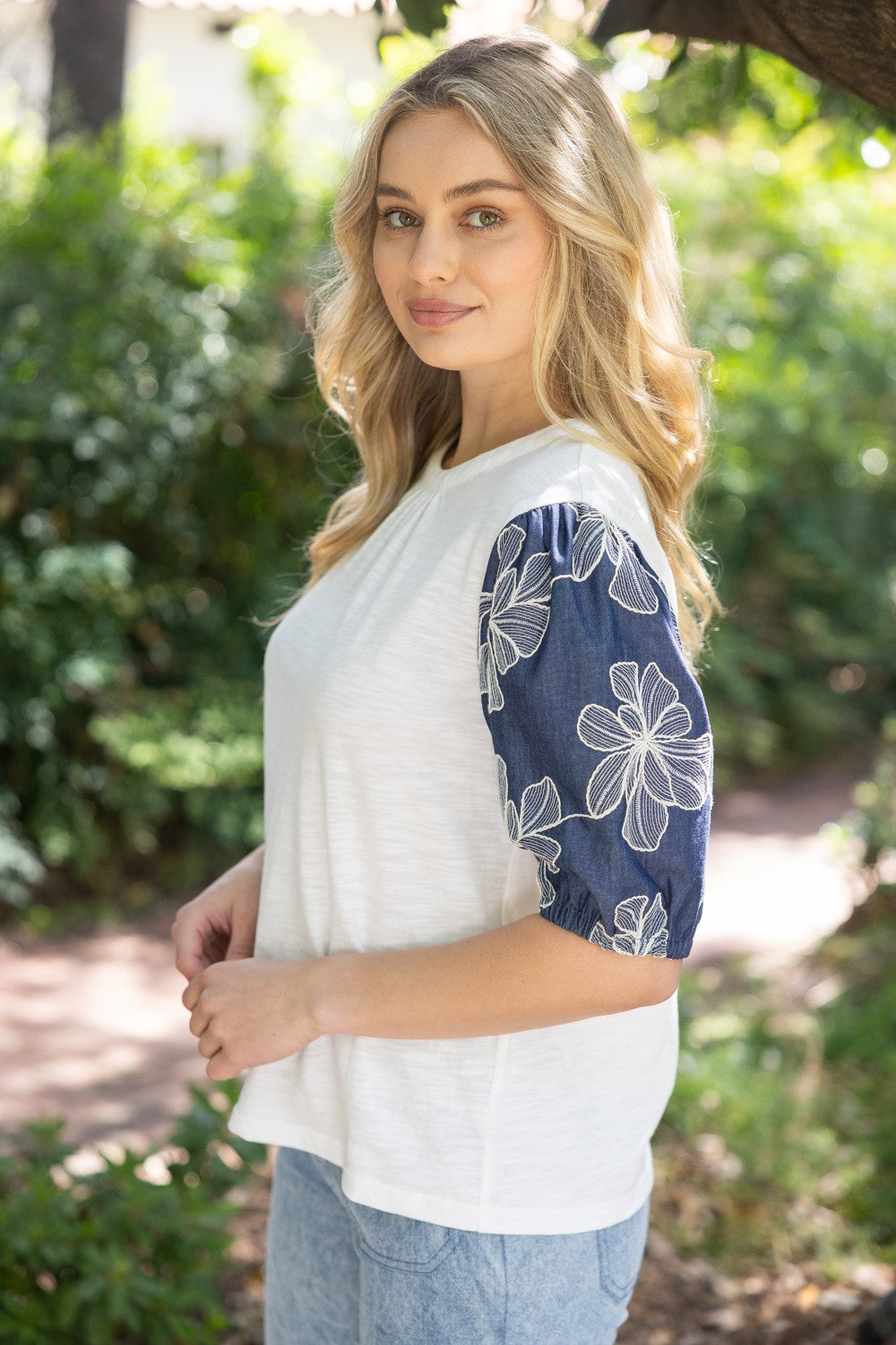 Floral embroidered puff sleeve slub knit top in soft neutral tone with feminine silhouette