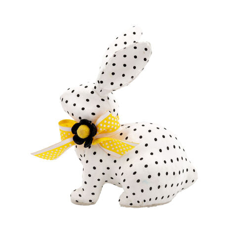 White rabbit figurine with black polka dot ears on a dark base