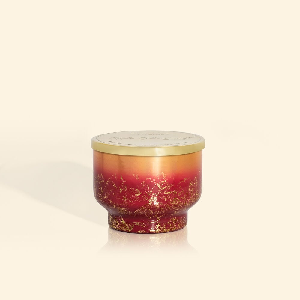 Inverted jar candle in Glimmer apple cider scent with a clear glass silhouette and visible wick.