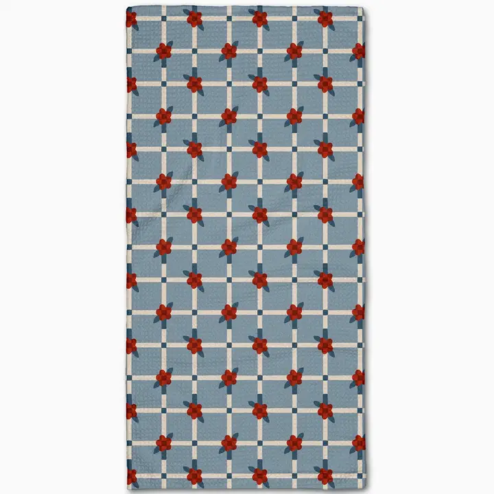Floral Parade Grid Bar Towel with a blue background, white grid, and red flower pattern.