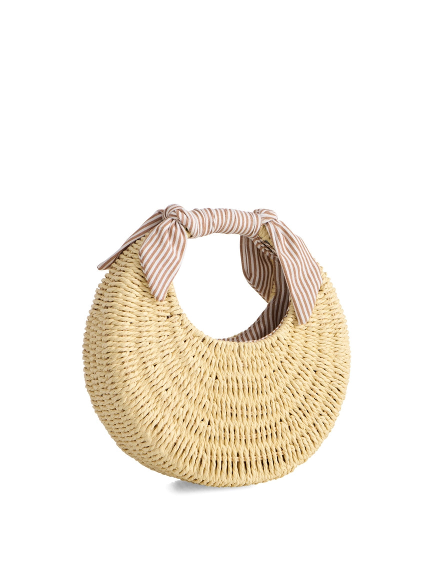 A woven straw crescent-shaped bag with a striped fabric handle tied in a knot.