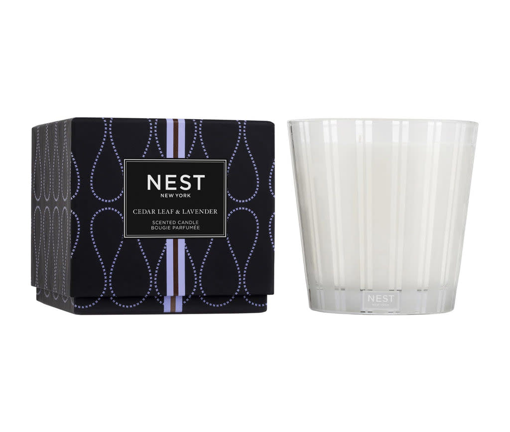 Nest 3-Wick Candle in a cylindrical glass jar with three wicks and neutral-colored wax.