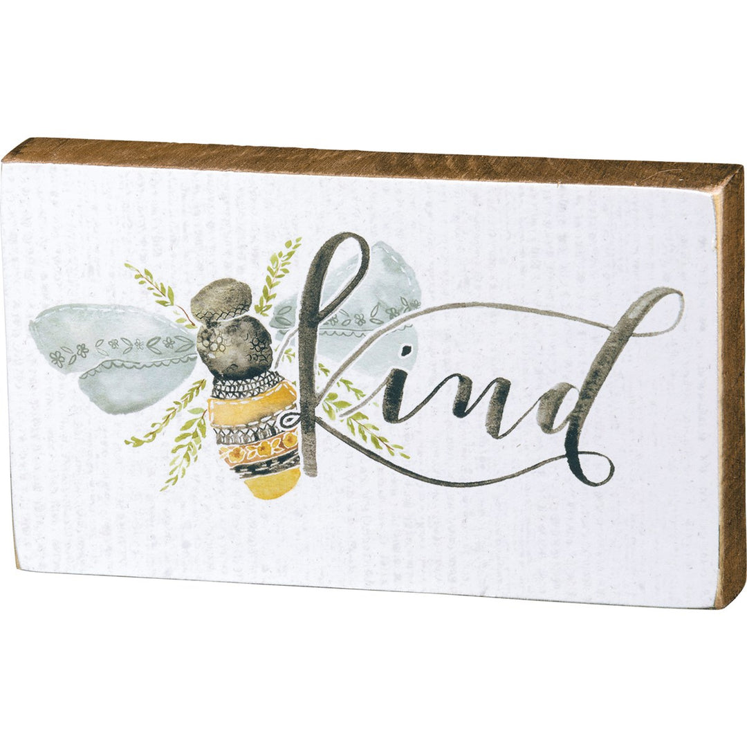 Wooden box sign with a watercolor bee and the word "kind" in script.