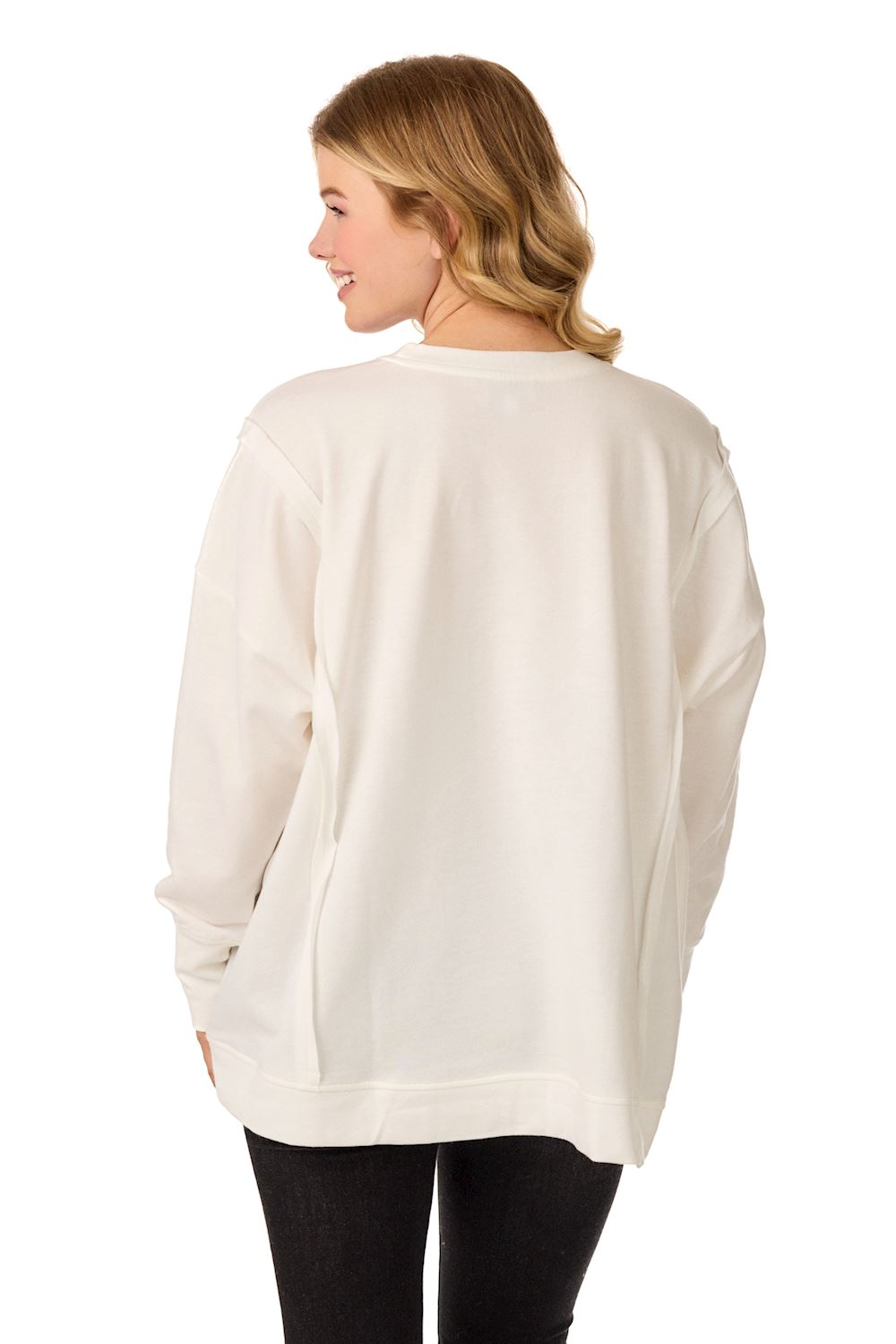 Back view of a woman wearing a white oversized Xoxo Sweatshirt with side slit hem.
