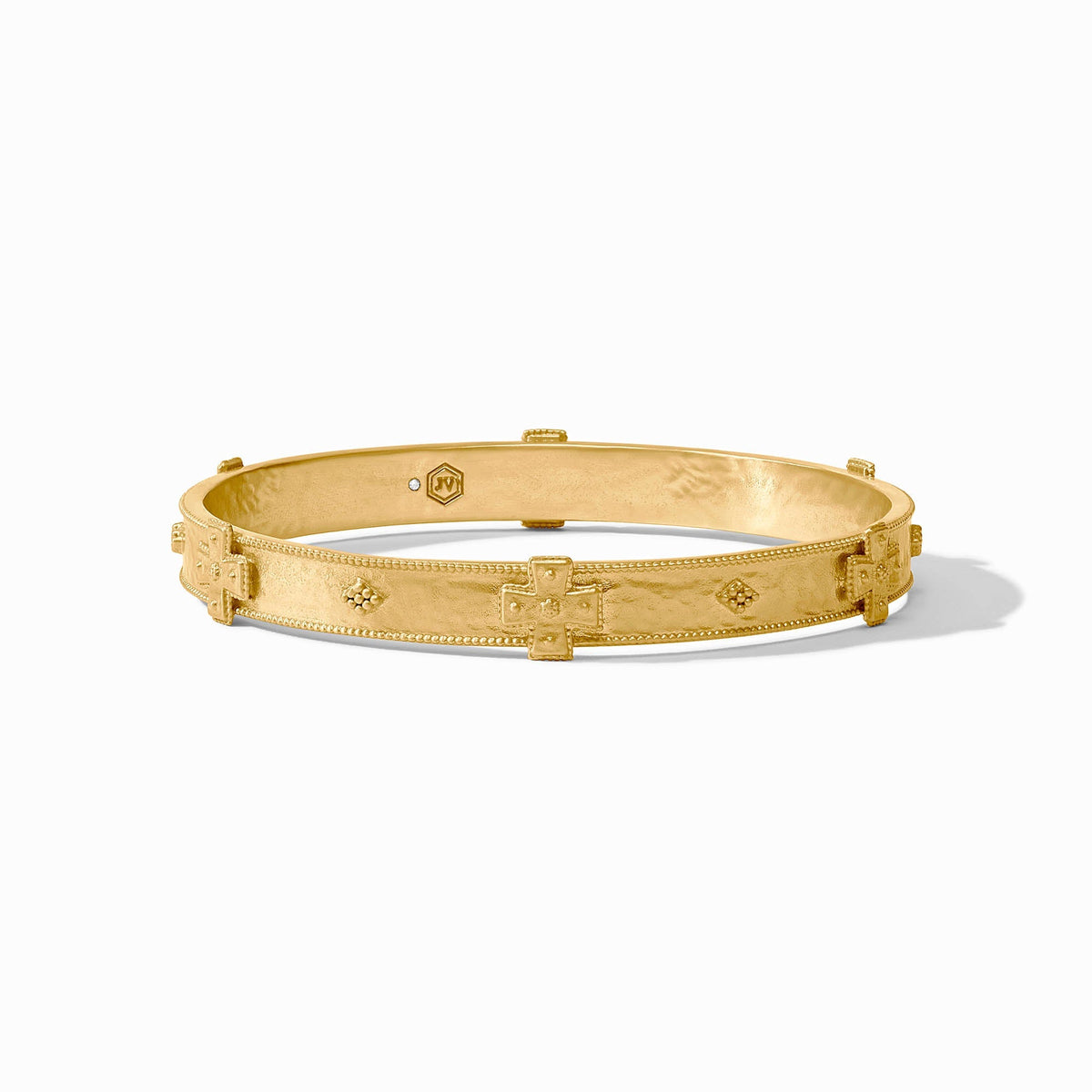 Gold-tone Canterbury bangle bracelet with a smooth cylindrical shape.