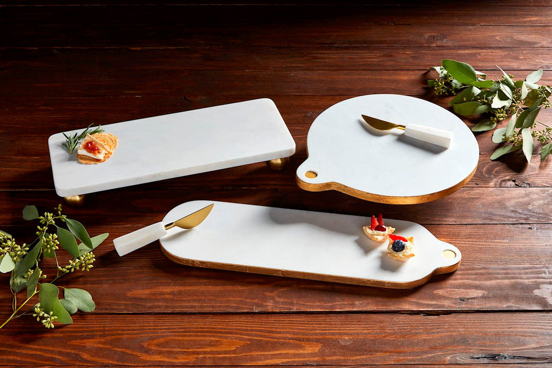 Gold-footed rectangular marble board measuring six by fifteen inches