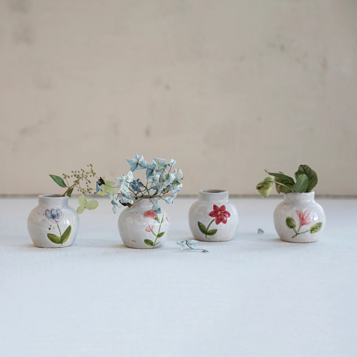 Hand-painted stoneware vase with floral motif in earthy tones