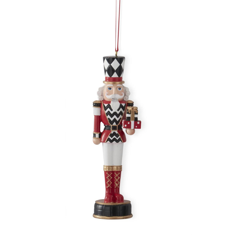6.25-inch nutcracker ornament with red jacket, harlequin hat, and gold trim holding a gift box.