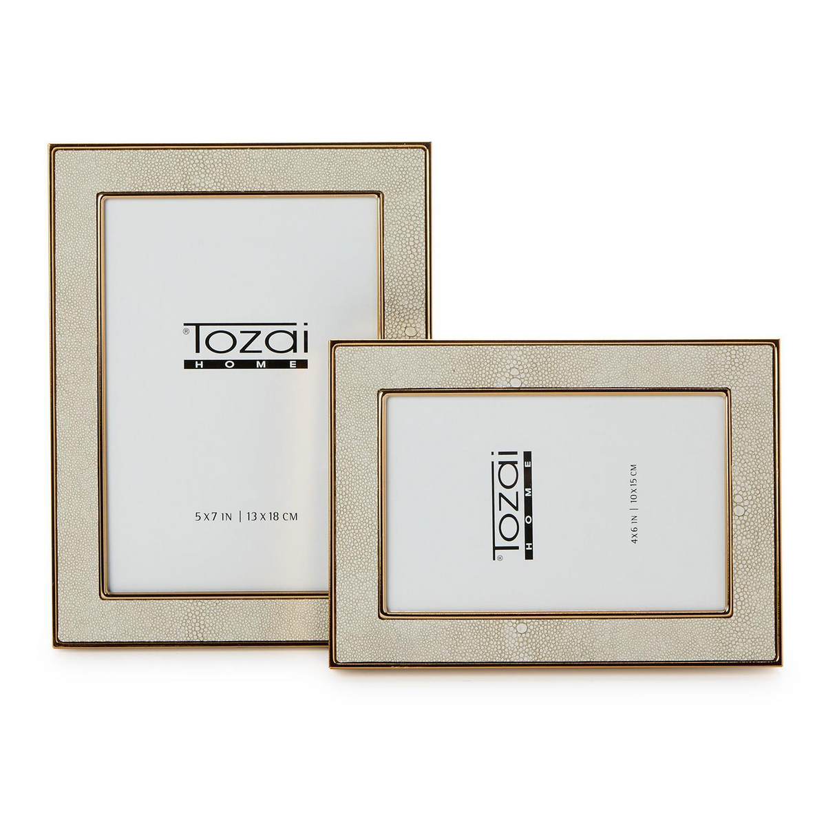 Two cream faux shagreen photo frames with gold steel trim in 5x7 and 4x6 sizes.