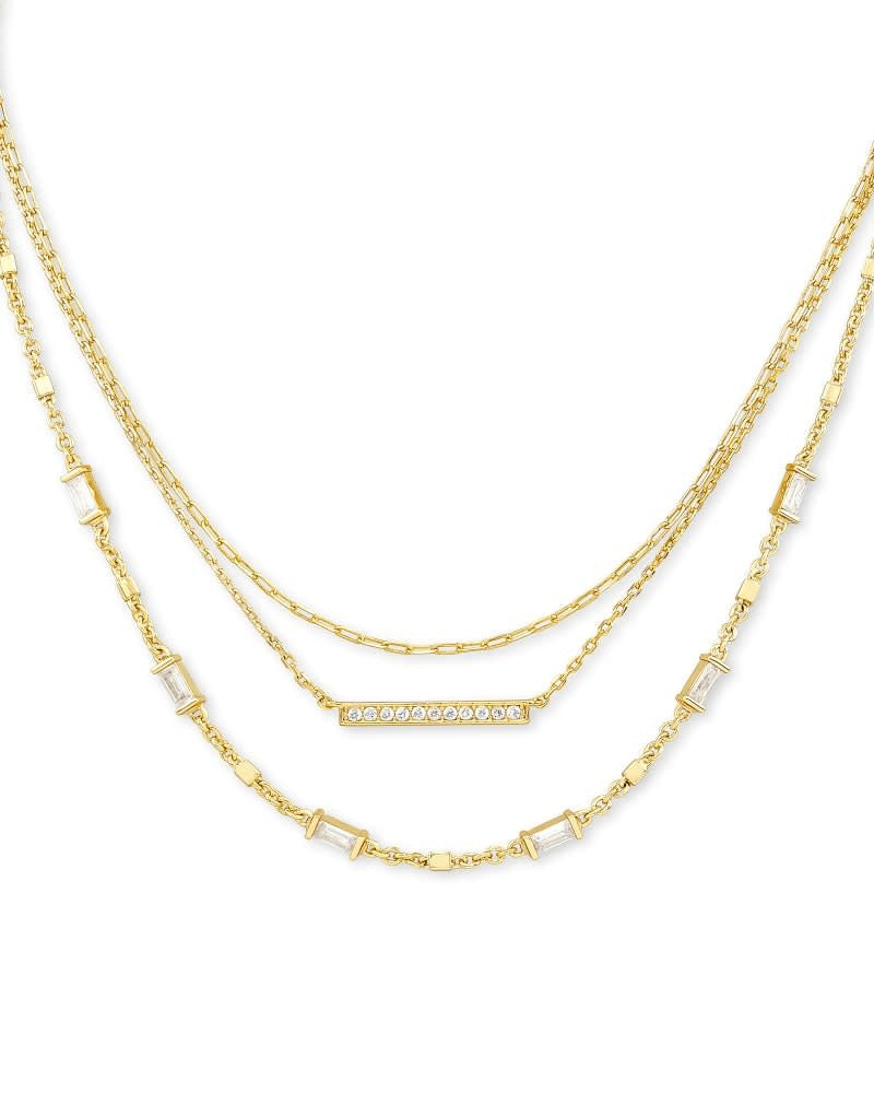 Gold multi-strand necklace with three layered chains on a lobster claw clasp.