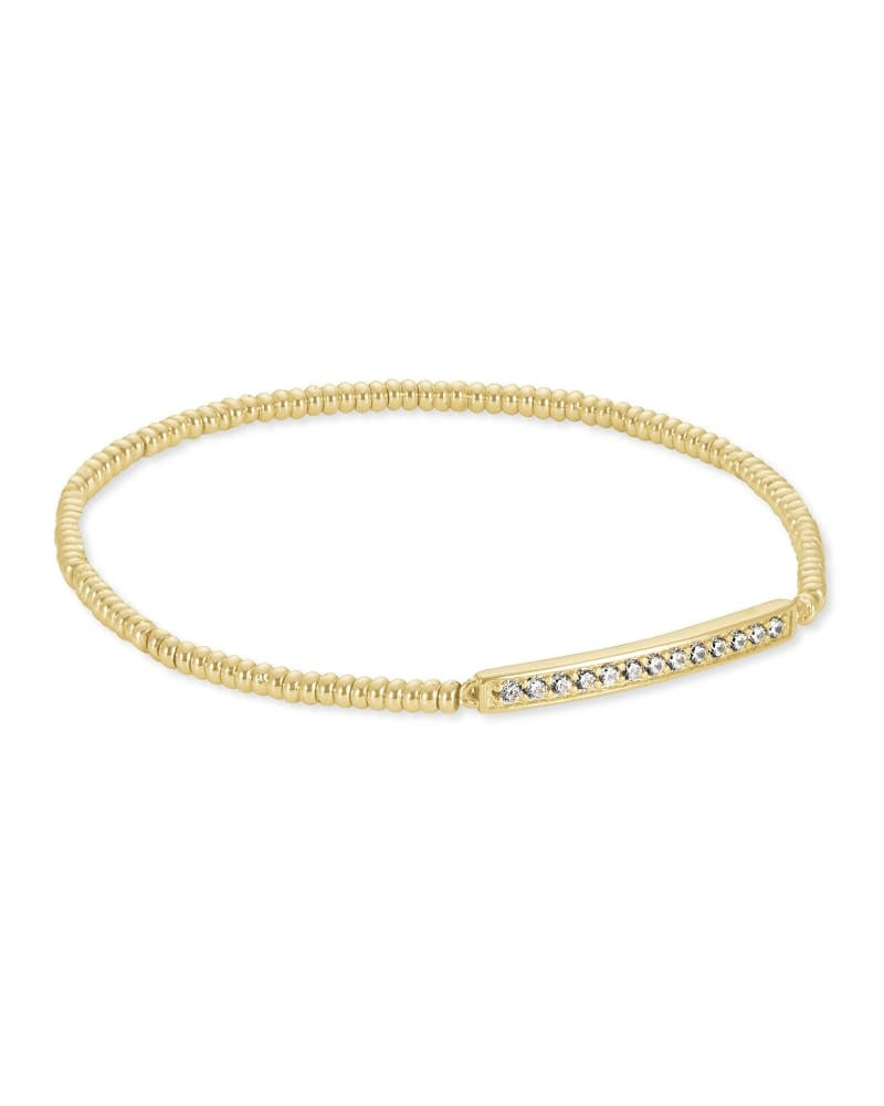 Gold stretch bracelet with subtle sparkle stations on a neutral background.
