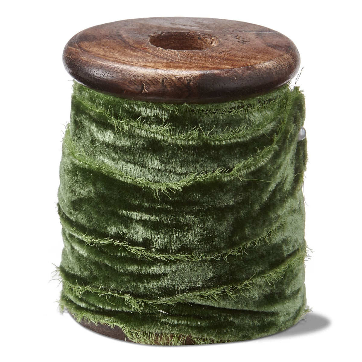 Emerald velvet ribbon spool wrapped around a mango wood stand with an antique pin.
