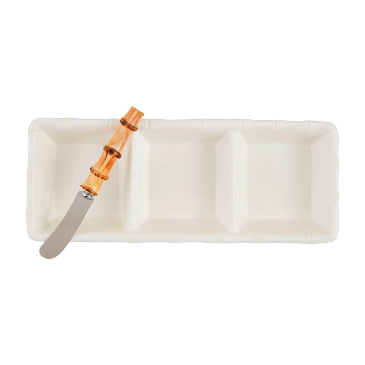 White stoneware triple tidbit tray with bamboo-style edges and a matching bamboo-handled spreader.