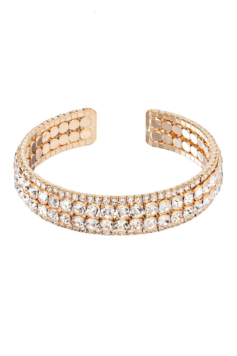 Gold-tone open cuff bracelet featuring four rows of clear shimmering rhinestones.